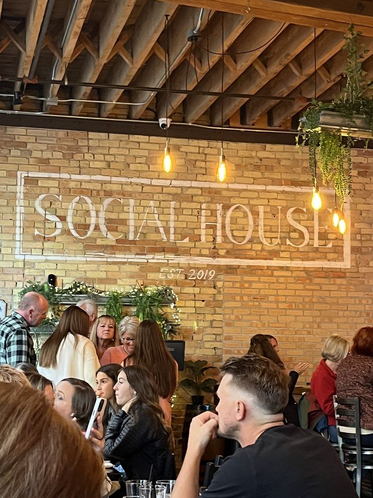 Social House Grand Rapids interior, crowd, neon signage on brick wall