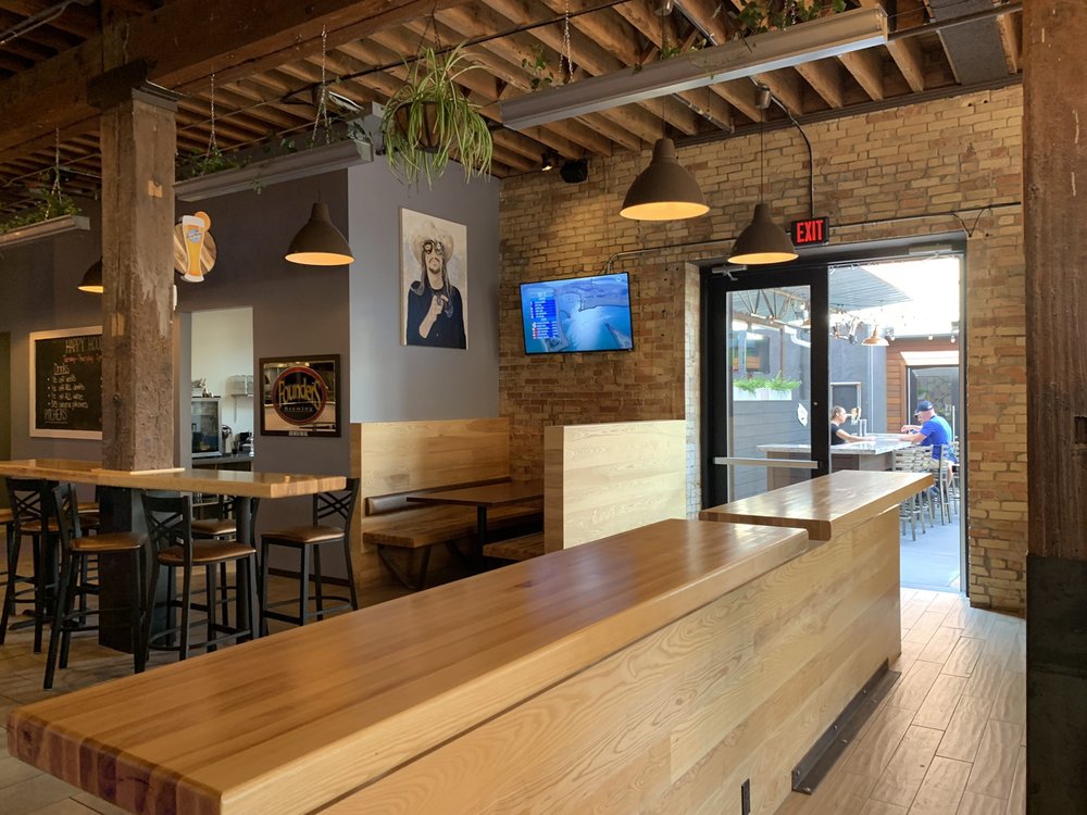 GR dining room, brick walls, wooden tables
